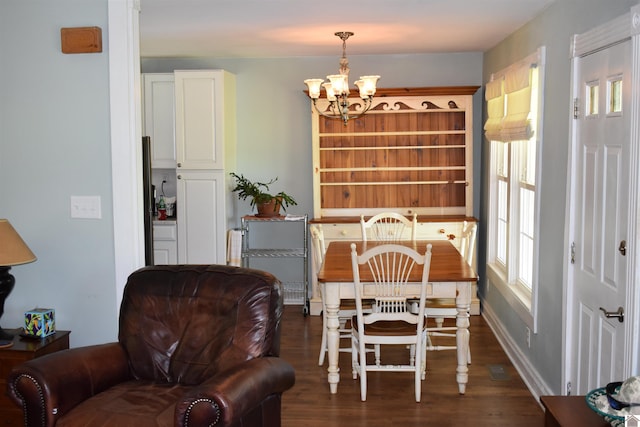3975 Contest Rd, Paducah, KY 42001 - dining area featuring a chandelier, dark wood finished floors, and baseboards