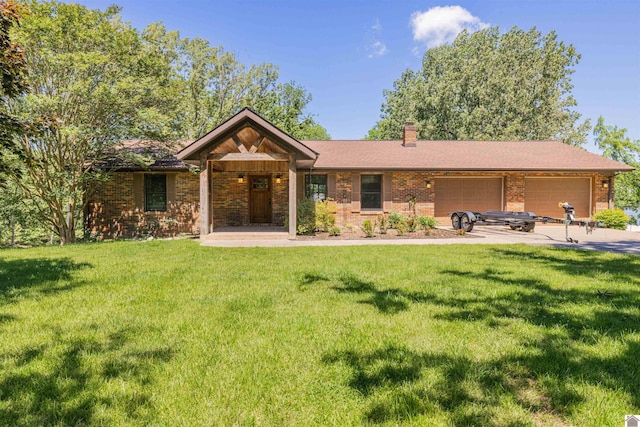 3011 Little Bear Hwy, Gilbertsville, KY 42044 - ranch-style home featuring a front lawn, a chimney, an attached garage, and brick siding