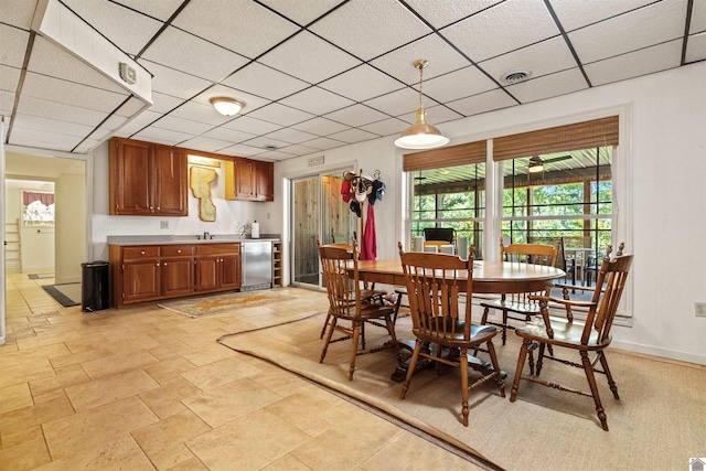 3011 Little Bear Hwy, Gilbertsville, KY 42044 - dining room featuring a drop ceiling, bar with sink, and baseboards