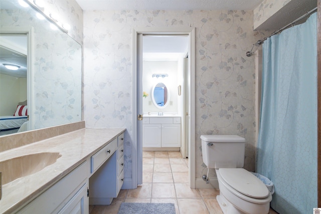 3011 Little Bear Hwy, Gilbertsville, KY 42044 - bathroom with wallpapered walls, vanity, tile patterned floors, connected bathroom, and toilet