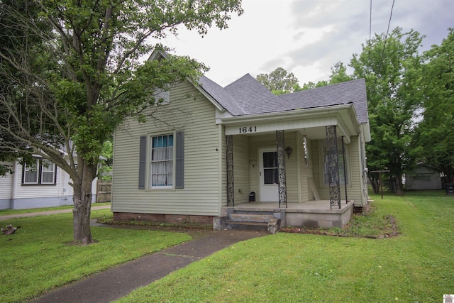 1641 Harrison, Paducah, KY 42001 - view of front of property featuring a porch, a shingled roof, and a front lawn