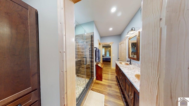 3210 Douglas Rd, Murray, KY 42071 - ensuite bathroom featuring wood finished floors, a stall shower, double vanity, and recessed lighting