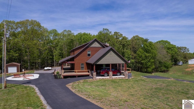 3210 Douglas Rd, Murray, KY 42071 - view of front facade with faux log siding, a front lawn, an outdoor structure, and driveway