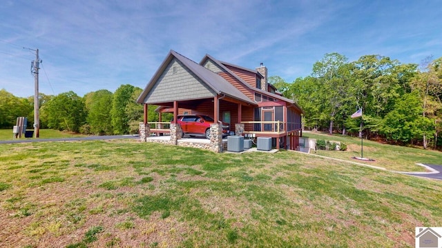 3210 Douglas Rd, Murray, KY 42071 - view of grassy yard featuring a carport and central AC unit