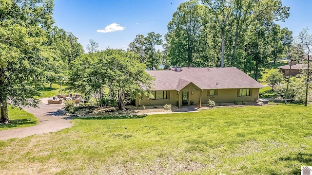 114 Shadyside Ln, Gilbertsville, KY 42044 - ranch-style home featuring a front lawn and view of scattered trees