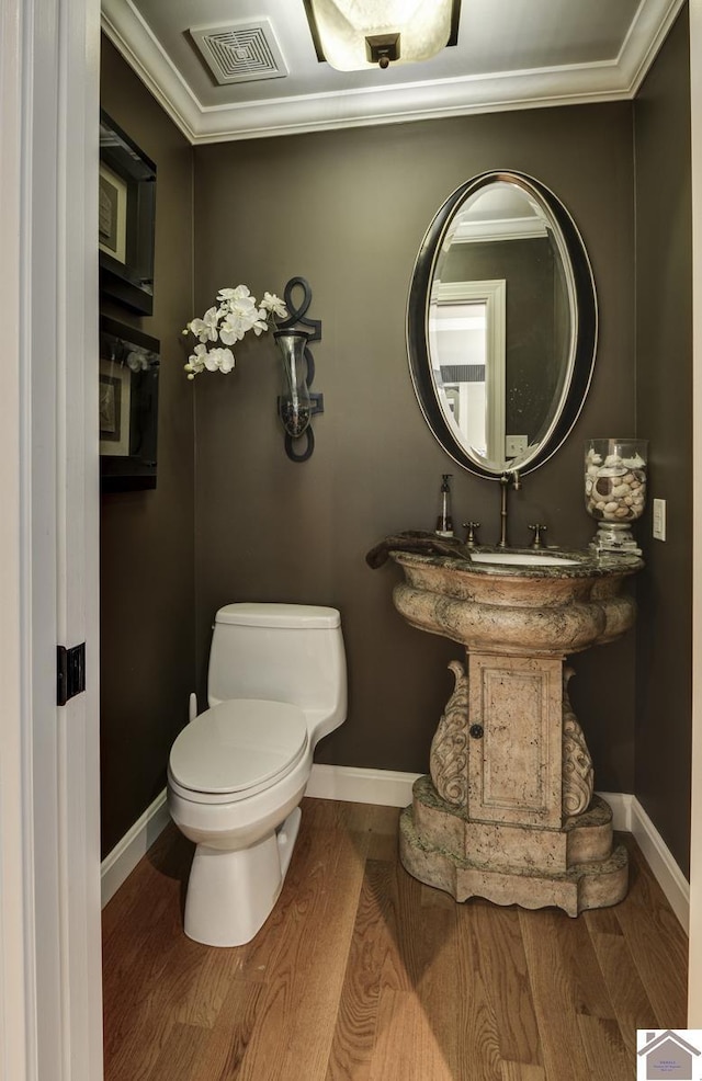 114 Shadyside Ln, Gilbertsville, KY 42044 - bathroom featuring toilet, wood finished floors, baseboards, and crown molding