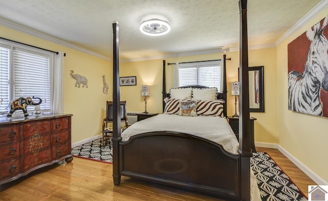 114 Shadyside Ln, Gilbertsville, KY 42044 - bedroom featuring wood finished floors, crown molding, baseboards, and a textured ceiling