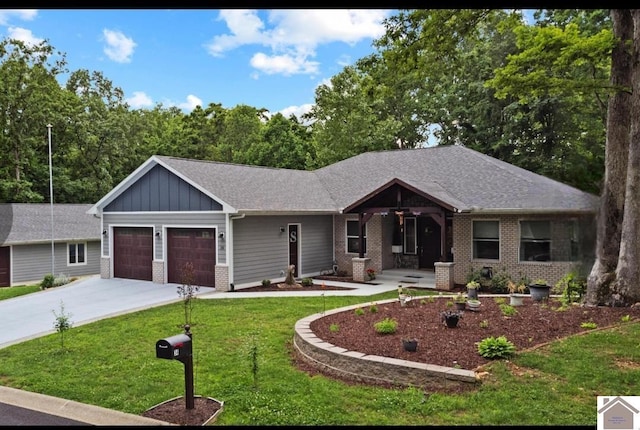 34 Navajo Ct, Cadiz, KY 42211 - view of front of property with board and batten siding, concrete driveway, a garage, a front yard, and brick siding