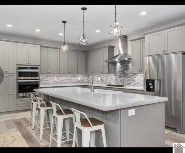 34 Navajo Ct, Cadiz, KY 42211 - kitchen featuring appliances with stainless steel finishes, wall chimney range hood, a sink, gray cabinetry, and light stone countertops