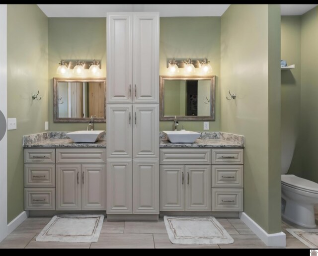 34 Navajo Ct, Cadiz, KY 42211 - full bathroom with double vanity, baseboards, and toilet