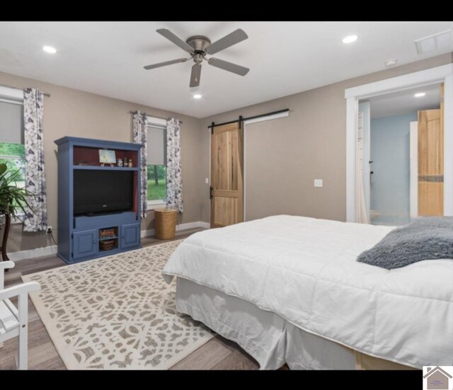 34 Navajo Ct, Cadiz, KY 42211 - bedroom with a barn door, wood finished floors, baseboards, recessed lighting, and ceiling fan