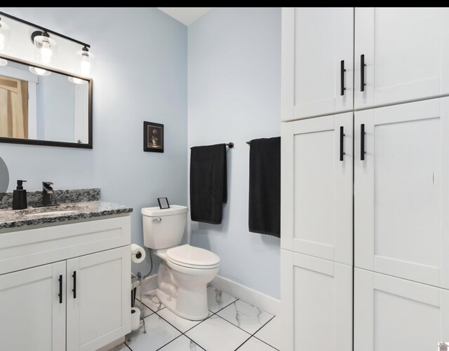 34 Navajo Ct, Cadiz, KY 42211 - bathroom with baseboards, vanity, toilet, and marble finish floors