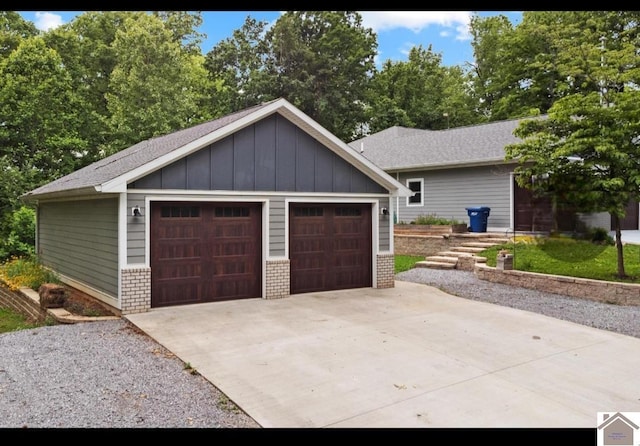 34 Navajo Ct, Cadiz, KY 42211 - view of front facade with a detached garage, board and batten siding, brick siding, and an outdoor structure