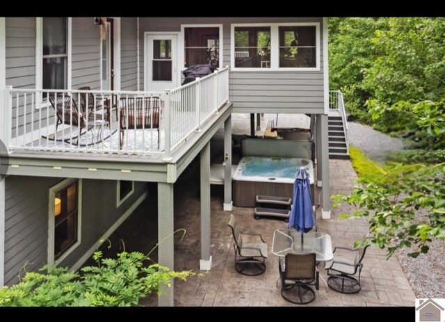 34 Navajo Ct, Cadiz, KY 42211 - back of house featuring a hot tub, a patio area, and stairway