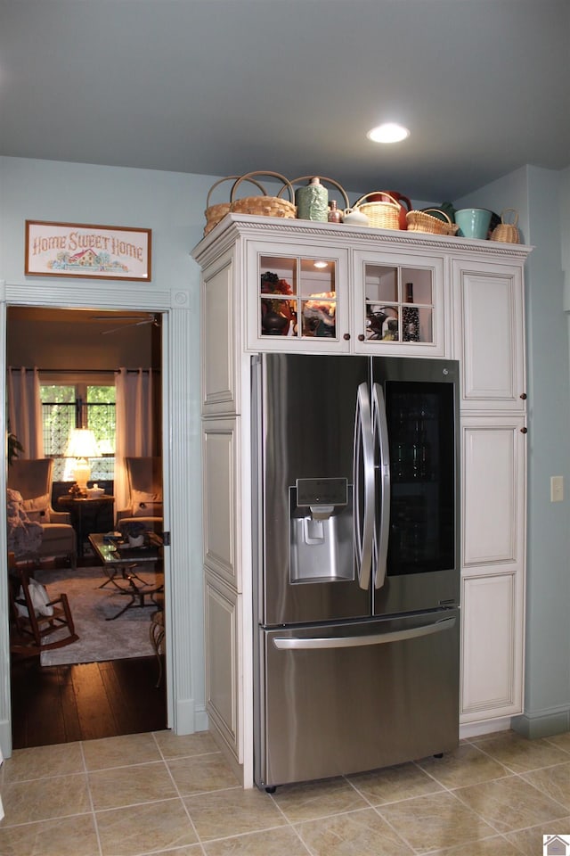 395 Wildcat Trce, Paducah, KY 42003 - kitchen with stainless steel fridge with ice dispenser, glass insert cabinets, and light tile patterned floors