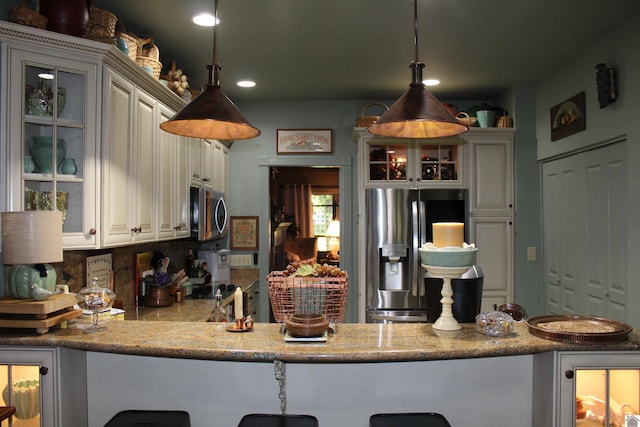395 Wildcat Trce, Paducah, KY 42003 - kitchen with appliances with stainless steel finishes, glass insert cabinets, hanging light fixtures, a peninsula, and recessed lighting