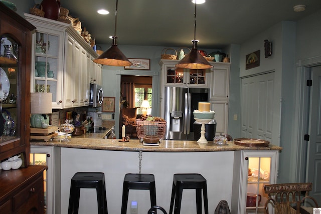395 Wildcat Trce, Paducah, KY 42003 - kitchen with stainless steel appliances, a peninsula, pendant lighting, glass insert cabinets, and recessed lighting