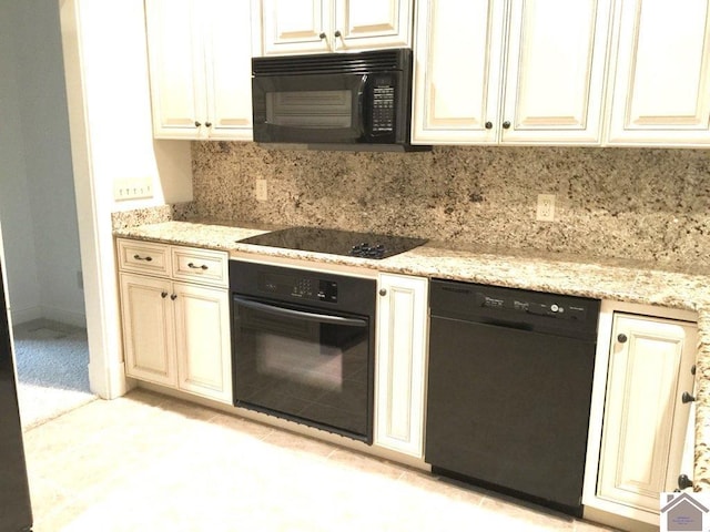 395 Wildcat Trce, Paducah, KY 42003 - kitchen with black appliances, cream cabinetry, decorative backsplash, light stone counters, and light tile patterned floors