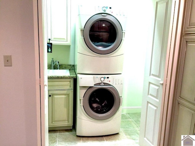 395 Wildcat Trce, Paducah, KY 42003 - laundry room featuring cabinet space, stacked washing machine and dryer, and light tile patterned flooring