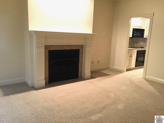 395 Wildcat Trce, Paducah, KY 42003 - detailed view of a fireplace, carpet, black appliances, baseboards, and backsplash