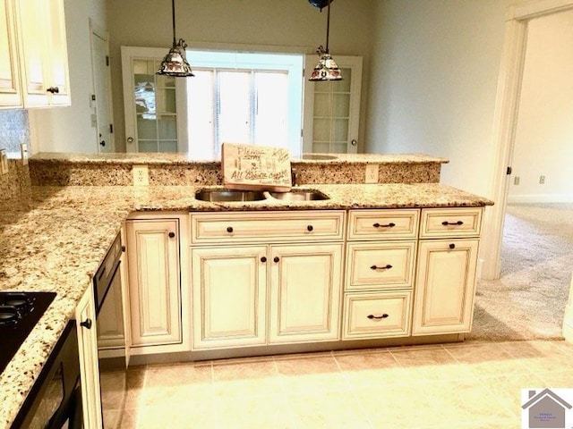 395 Wildcat Trce, Paducah, KY 42003 - kitchen with cream cabinetry, light stone countertops, and a sink