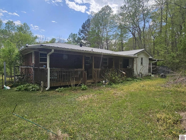 6694 State Line Rd E, Hazel, KY 42049 - back of house with a lawn, metal roof, and a deck