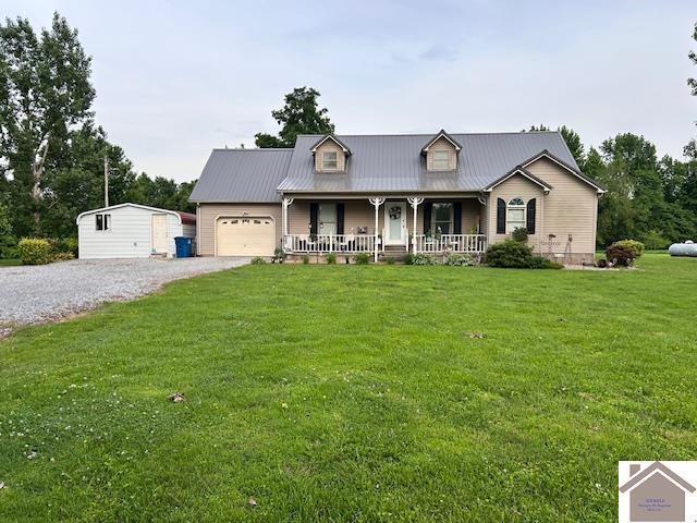 5812 State Route 123, Arlington, KY 42021 - view of front of home featuring covered porch, an attached garage, a front lawn, driveway, and metal roof