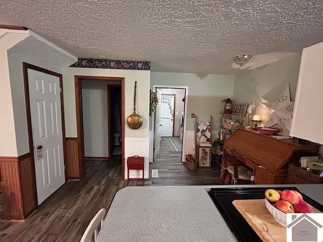 5812 State Route 123, Arlington, KY 42021 - dining room featuring wood finished floors, a textured ceiling, and wainscoting