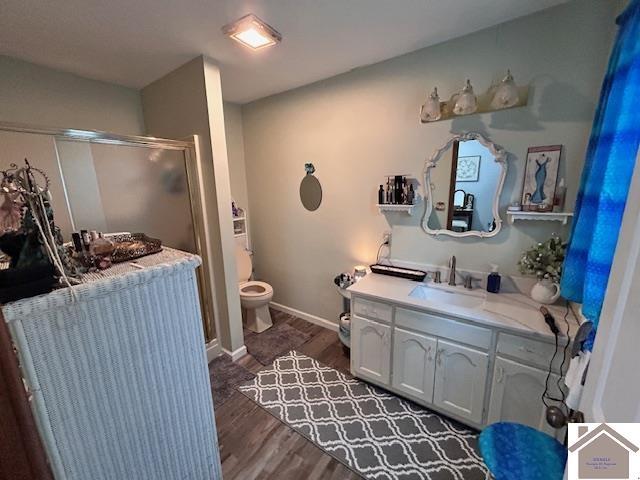 5812 State Route 123, Arlington, KY 42021 - bathroom featuring vanity, a shower stall, wood finished floors, toilet, and baseboards