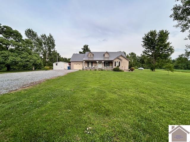 5812 State Route 123, Arlington, KY 42021 - cape cod-style house with a front yard, gravel driveway, and an attached garage