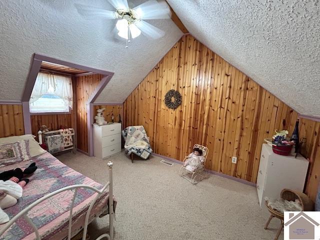 5812 State Route 123, Arlington, KY 42021 - carpeted bedroom featuring wooden walls, a textured ceiling, lofted ceiling, and ceiling fan