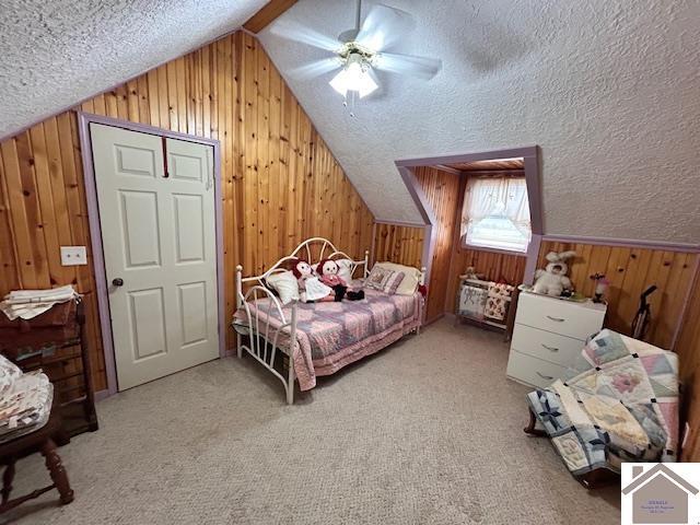 5812 State Route 123, Arlington, KY 42021 - bedroom with wooden walls, lofted ceiling, a textured ceiling, a ceiling fan, and carpet floors