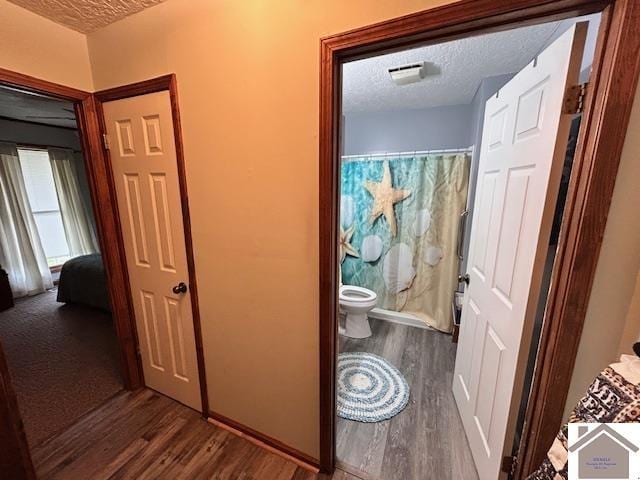 5812 State Route 123, Arlington, KY 42021 - full bathroom with a textured ceiling, wood finished floors, toilet, and a shower with shower curtain