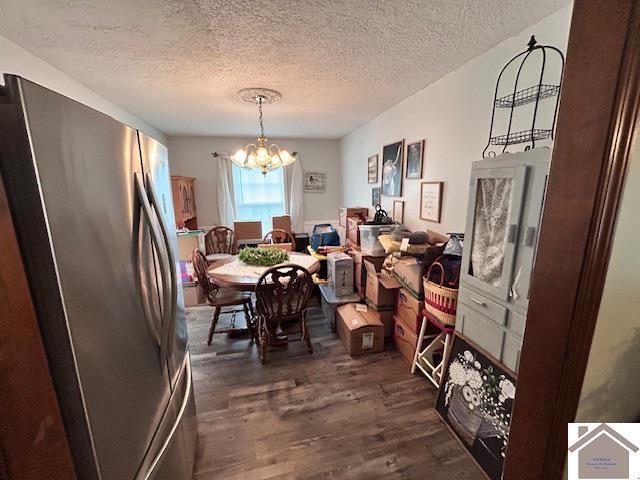 5812 State Route 123, Arlington, KY 42021 - dining space with a chandelier, dark wood-style flooring, and a textured ceiling