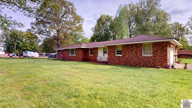 199 Park St, Gilbertsville, KY 42044 - ranch-style home with an attached garage, a front yard, and brick siding