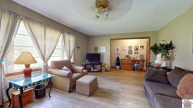 199 Park St, Gilbertsville, KY 42044 - living room featuring a textured ceiling, ceiling fan, and light wood-style flooring