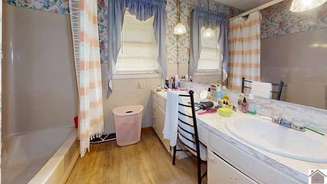 199 Park St, Gilbertsville, KY 42044 - bathroom with wallpapered walls, vanity, wood finished floors, shower / tub combo, and a wainscoted wall