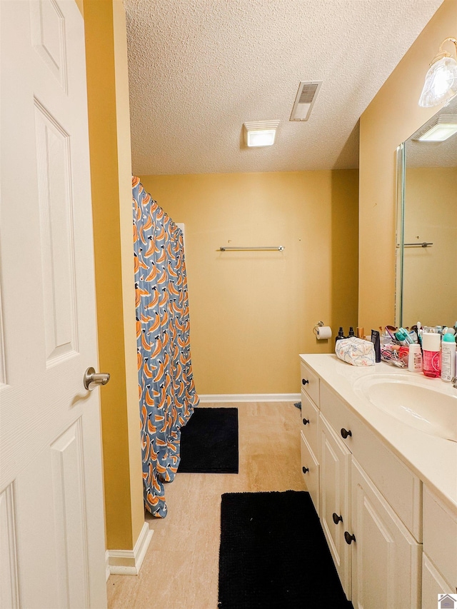 145 Stonecreek Pl, Paducah, KY 42003 - bathroom with vanity, a textured ceiling, baseboards, and a shower with curtain