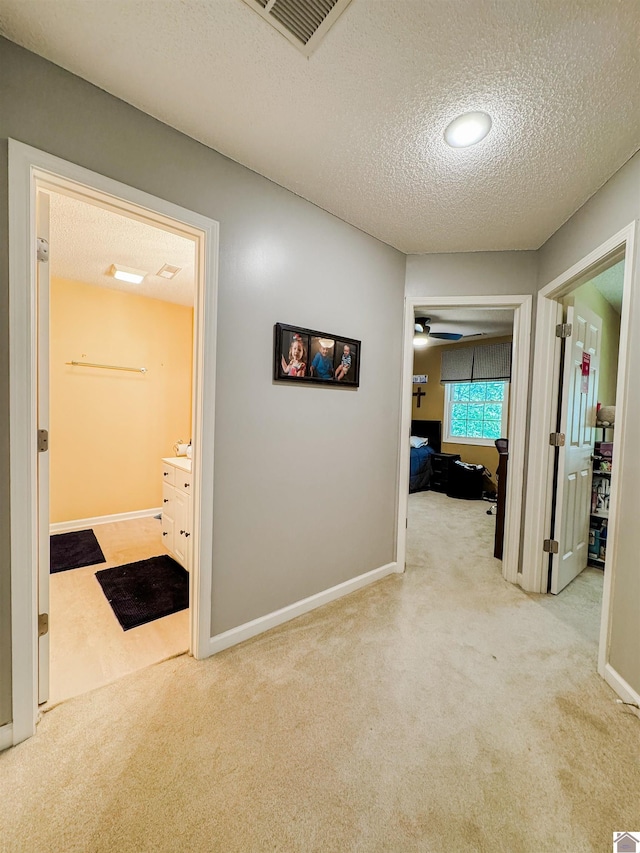 145 Stonecreek Pl, Paducah, KY 42003 - hall with carpet flooring, a textured ceiling, and baseboards