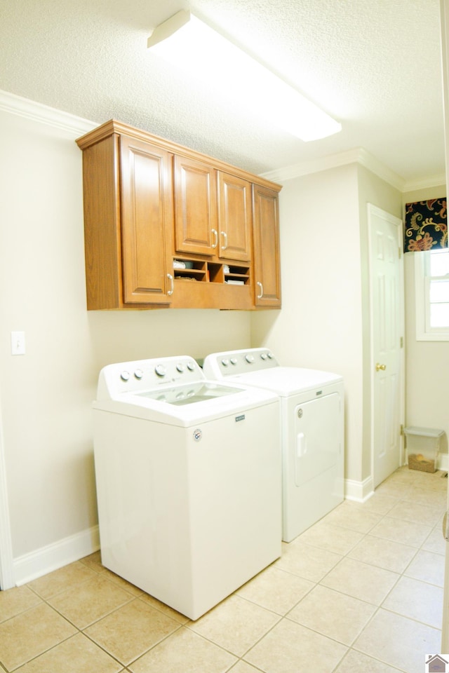 145 Stonecreek Pl, Paducah, KY 42003 - laundry room with washer and dryer, cabinet space, a textured ceiling, ornamental molding, and light tile patterned flooring