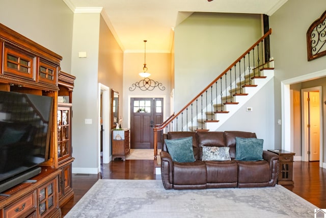 145 Stonecreek Pl, Paducah, KY 42003 - living room featuring a towering ceiling, stairway, dark wood-style flooring, ornamental molding, and baseboards