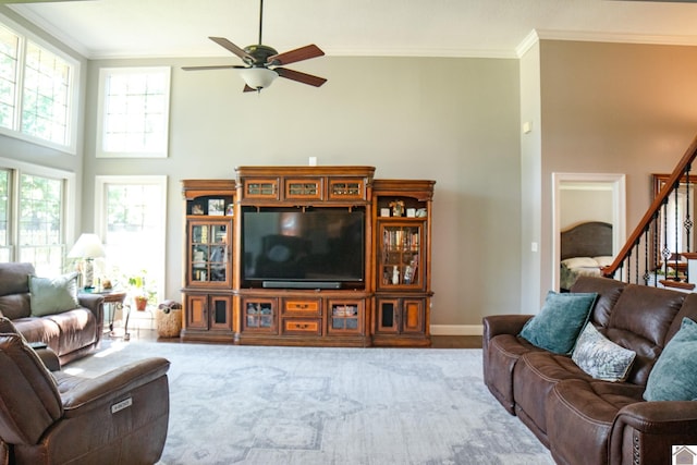 145 Stonecreek Pl, Paducah, KY 42003 - living area featuring a ceiling fan, a towering ceiling, ornamental molding, stairway, and baseboards