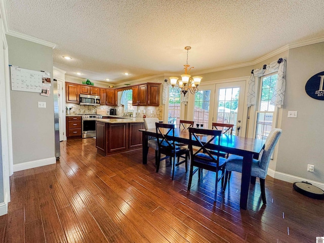 145 Stonecreek Pl, Paducah, KY 42003 - dining area featuring a chandelier, a textured ceiling, dark wood-style floors, crown molding, and baseboards