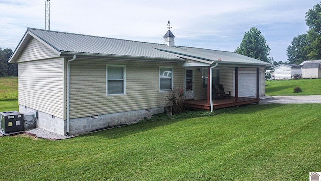 827 State Route 1271, Kuttawa, KY 42055 - back of property featuring crawl space, a garage, a lawn, and central air condition unit