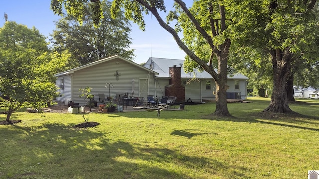 3730 Metropolis Lake Rd, West Paducah, KY 42086 - rear view of property featuring a lawn, a patio, and central AC
