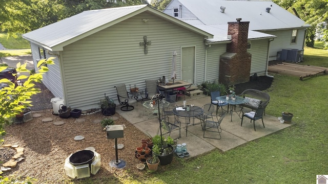 3730 Metropolis Lake Rd, West Paducah, KY 42086 - rear view of house with a lawn, cooling unit, and a patio area