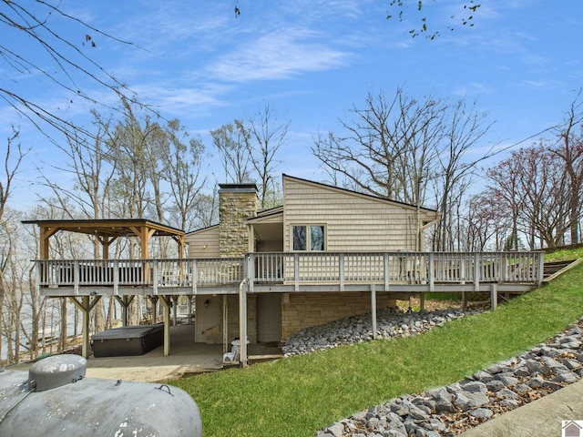695 Bayshore, Cadiz, KY 42211 - rear view of property featuring a hot tub, a wooden deck, a patio area, a chimney, and a yard