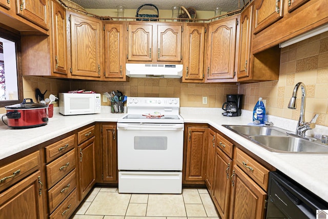 251 Hickory Hill Ln, Benton, KY 42025 - kitchen featuring white appliances, under cabinet range hood, a sink, brown cabinets, and light countertops