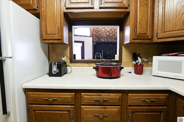 251 Hickory Hill Ln, Benton, KY 42025 - kitchen featuring white appliances, light countertops, backsplash, and brown cabinets