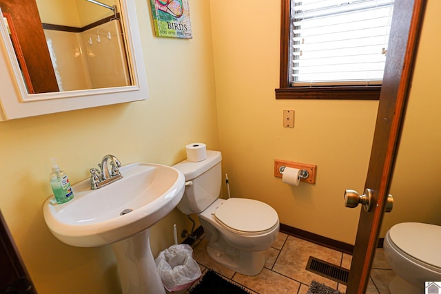 251 Hickory Hill Ln, Benton, KY 42025 - bathroom featuring toilet, tile patterned flooring, baseboards, a shower, and a sink